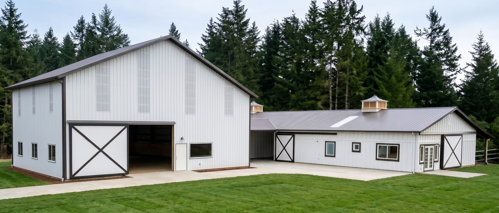 White post-frame shop and garage complex on a rural Oregon property, built by Miner Pole Buildings